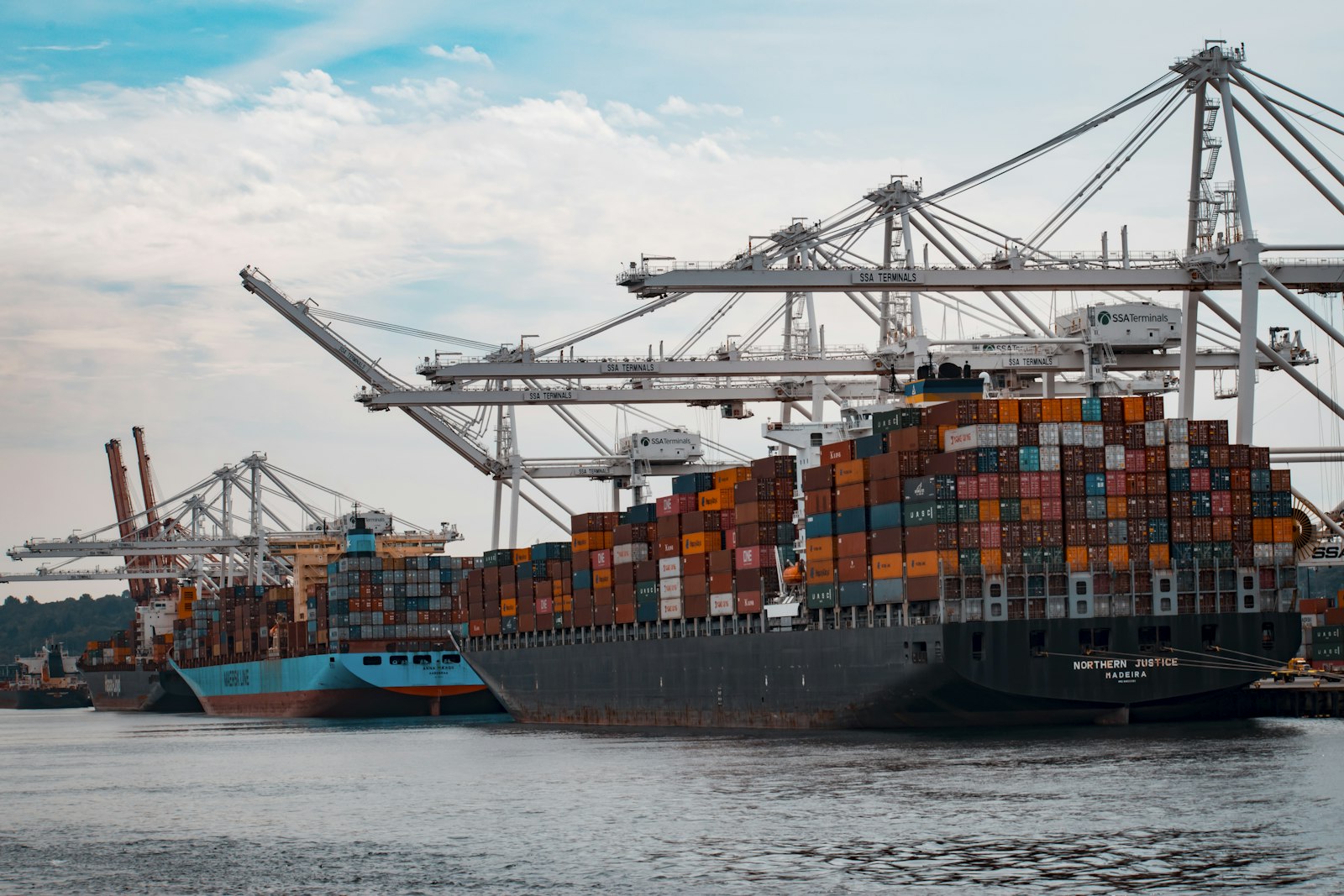 A cargo vessel alongside, the kind of ship that moves fuel from supply hubs